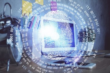 Computer on desktop in office with finger print drawing. Double exposure. Concept of business data...