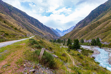 Mountain landscape with a river and a waterfall. Summer background. Belogorka gorge, Kyrgyzstan