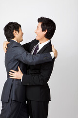 young businessmen hugging each other