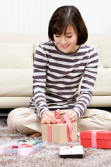 young woman packing a present