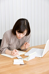 young woman keeping household accounts