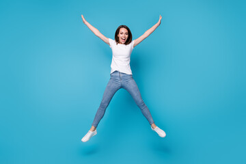 Fototapeta na wymiar Full length body size view of her she nice attractive funky careless slim fit thin skinny cheerful cheery girl jumping having fun holiday isolated bright vivid shine vibrant blue color background