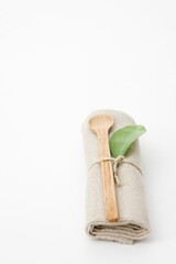 rolled napkin with leaf and wooden spoon