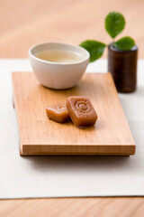 korean traditional cookie with cup of tea on wooden plate