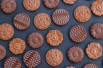 Milky and bitter round shape chocolate Madlen,designed on black background.The Sugar Feast or any festival celebration.Top view.