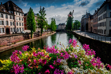 Flowers on a bridge over the river Ill in Strasbourg, France - obrazy, fototapety, plakaty