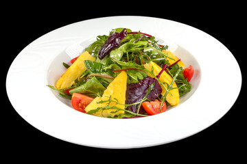 Delicious salad with maize porridge, arugula and tomatoes on a plate