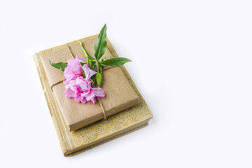 Romantic vintage still life with old book and pretty gift box wrapped with craft paper and...