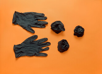 Halloween 2020 orange background with black latex gloves