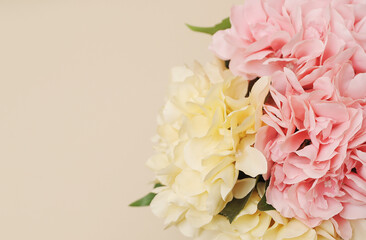 artificial branches of flowers on beige monochromatic background