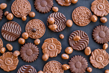 Milky and bitter round shape chocolate Madlen,designed on black background with dark ball chocolates.The Sugar Feast or any festival celebration.Top view.