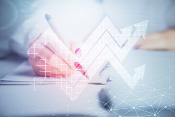 Blue arrow over woman's hands taking notes background. Concept of success. Double exposure