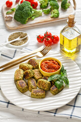 baked broccoli tots on a plate, top view