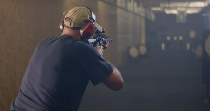 Unrecognizable man practicing in shooting range