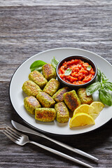 baked broccoli tots on a grey plate, top view