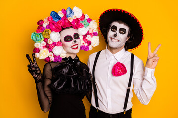 Portrait of his he her she glamorous spooky baleful cheerful couple zombie showing v-sign having...