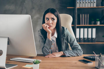 Photo of worried horrified girl sit desk work remote computer bite finger nails feel fear about...