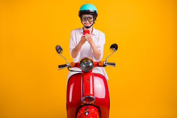 Photo of positive girl ride drive scooter use smartphone search location destination online wear...
