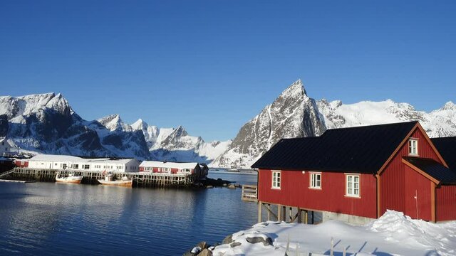 famous traditional multicolored wooden fishing houses rorbu on a sea shore at Lofoten archipelago, nothern Norway
