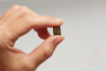 Woman holding miniature bible with fingers