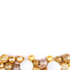 Festive white background with gold Christmas decorations. Flat lay, top view.