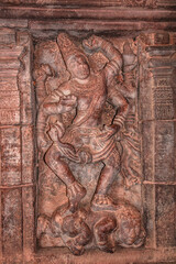 sculptures of hindu gods on facade of 7th century temple carved walls in Pattadakal