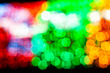 unfocused blurred glowing christmas multicolored lights with bokeh effect