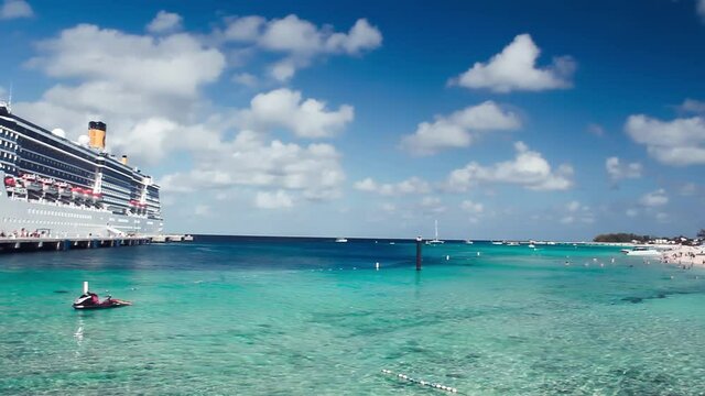 TURKS AND CAICOS ISLAND - FEBUARY 2012: Cruise ship with tourists along the beautiful beach. Slow motion
