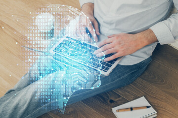 Businessman with computer background with brain theme hologram. Concept of brainstorm. Multi exposure.