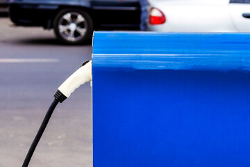  Electric Car Charging Column. Electric vehicle charging station for home with EV car background....