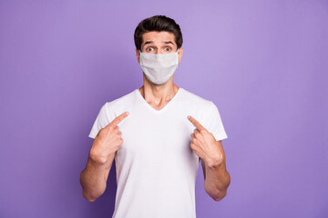 Portrait of his he nice attractive healthy scared guy pointing at himself wearing safety mask medicine syndrome symptom sickness illness isolated lilac violet purple pastel color background