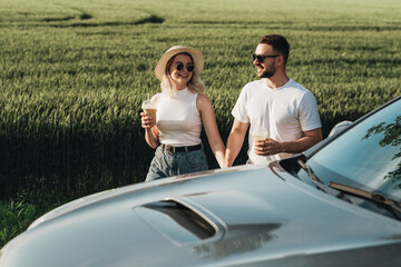 Man and Woman Having Good Time Near Their Car, Drinking Cold Coffee and Enjoying Adventure Road Trip