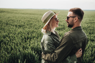 Man and Woman Dressed Alike in Olive Jacket Having a Good Time Outside the City