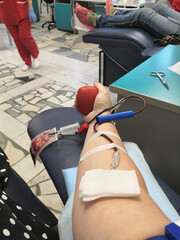 Blood donor at donation with a bouncy ball holding in hand.Also concept image for World blood donor...