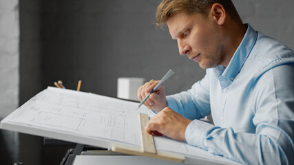 Young architect drawing a conctruction plan