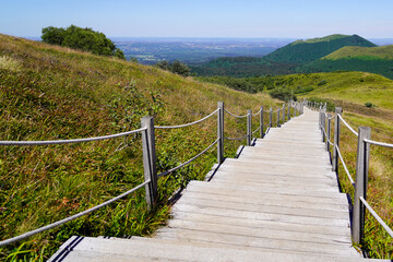 Fototapeta na wymiar Stairs wood pathway of the Puy de Dôme volcano mountain in mountain center of france