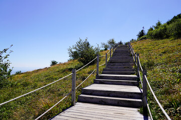 Fototapeta na wymiar wooden stairs access to the Puy de Dôme volcano mountain from Puy Pariou in Auvergne france