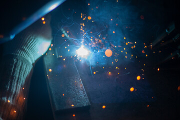 Metal welding. Sparks fly from the hot metal.