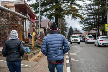 A married couple is walking around the city. 