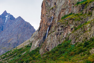 Mountain landscape with a river and a waterfall. Summer background. Belogorka gorge, Kyrgyzstan