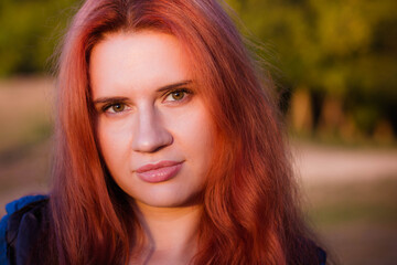 Fototapeta premium portrait of a young red-haired girl in the park