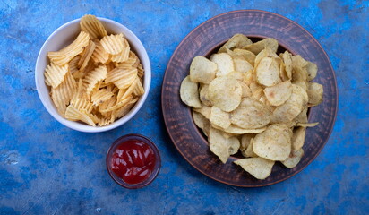 Potato Chips on an old wooden table. Close up food photo