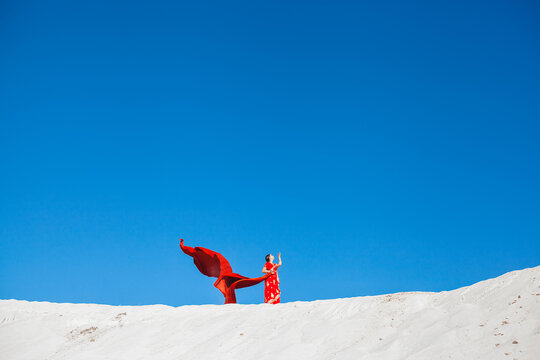 Indian woman on the top of sand barkhan.
