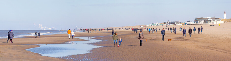 Noordwijk, Netherlands: sunny clear winterday at the beach; on the horizon smoke stacks in IJmuiden...