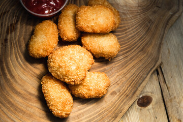 Chicken nuggets on a wooden board. Fast food concept