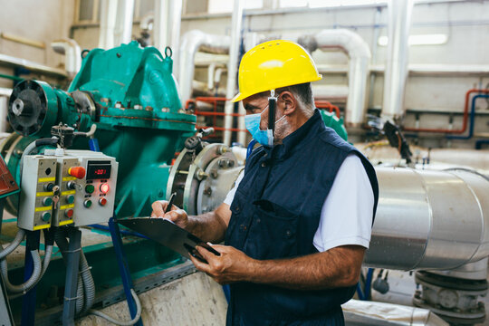 Industry Worker Working Indoor In Heating Plant Wearing Face Mask