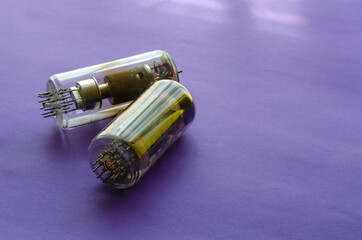 Two random vacuum tubes on a blue background.