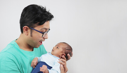 a father making funny face at his baby isolated in white background with space for text