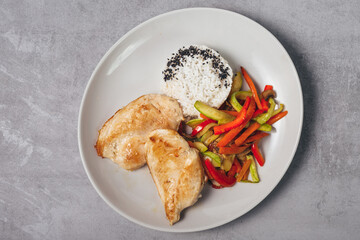 top view of grilled chicken breasts and roasted vegetable