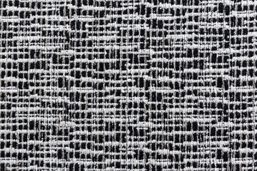 Extreme close-up of a black and white furniture fabric material, top view. High resolution full...